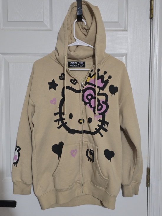 Hello Kitty Tops - Hello Kitty Beige Hoodie with Pink Bow and Black Graphic